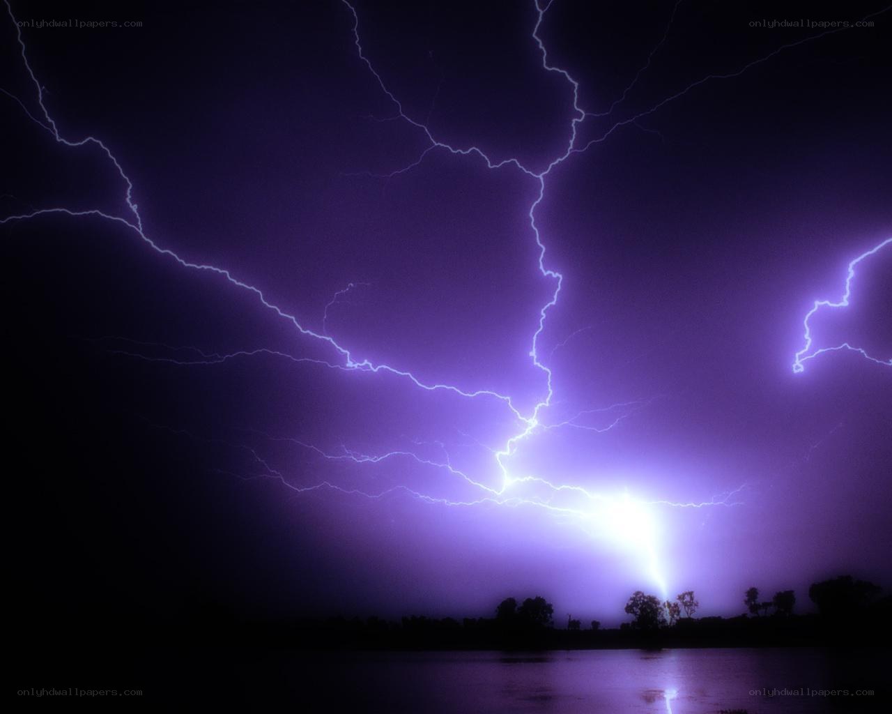 Purple lightning storm over water