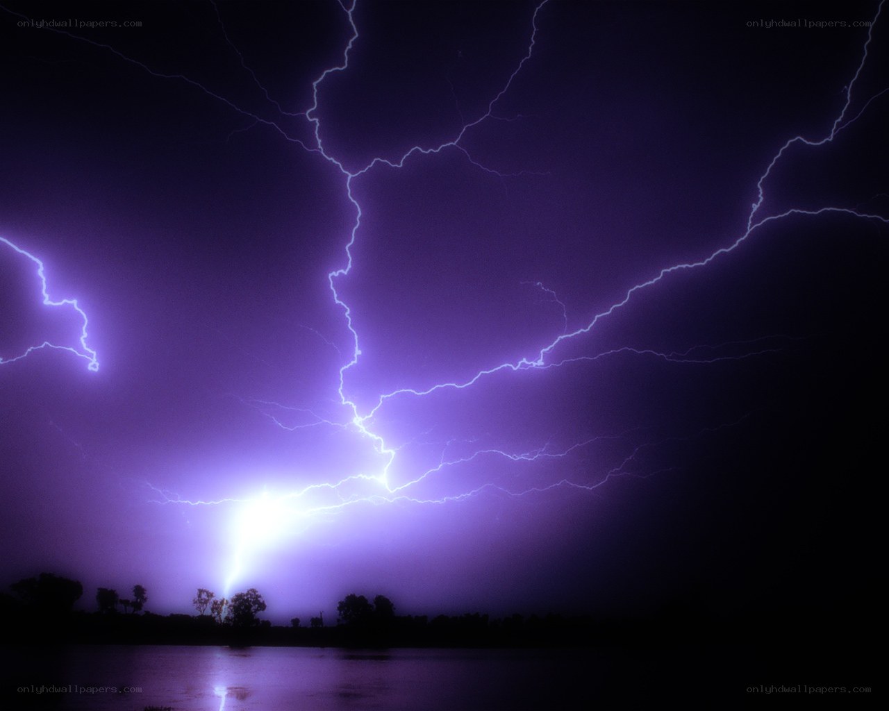 Purple lightning storm over water