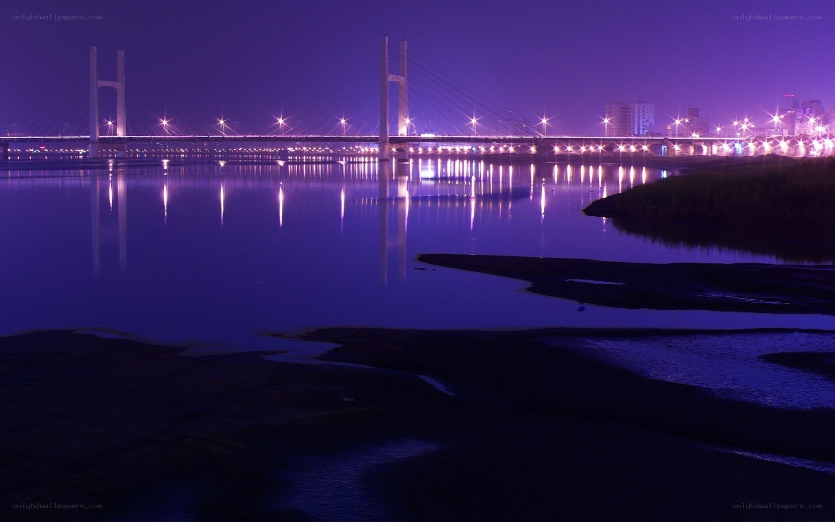 Purple-lit bridge at night
