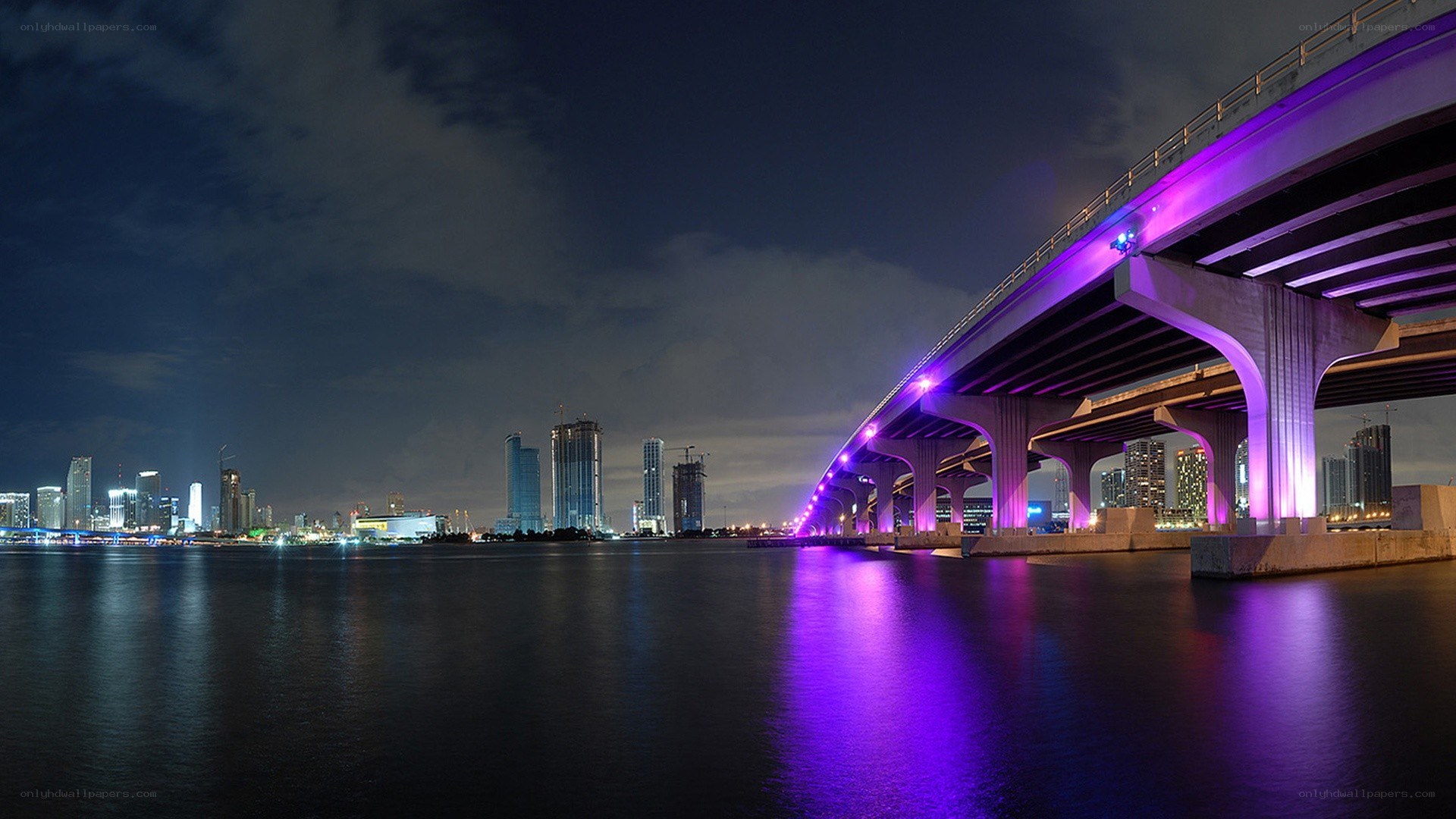 Purple-lit bridge at night