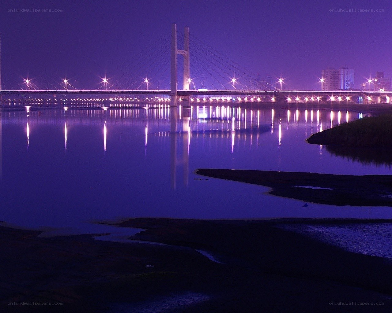 Purple-lit bridge at night