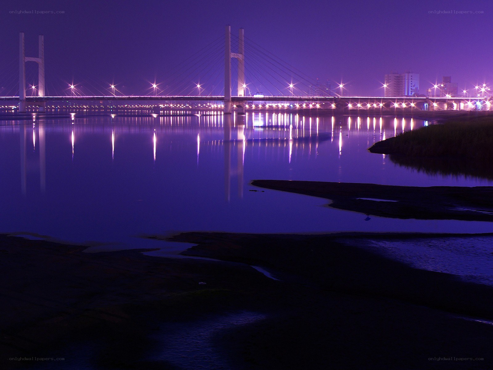 Purple-lit bridge at night