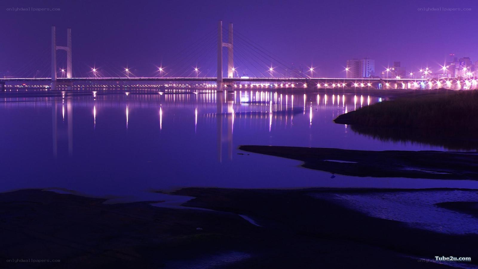 Purple-lit bridge at night
