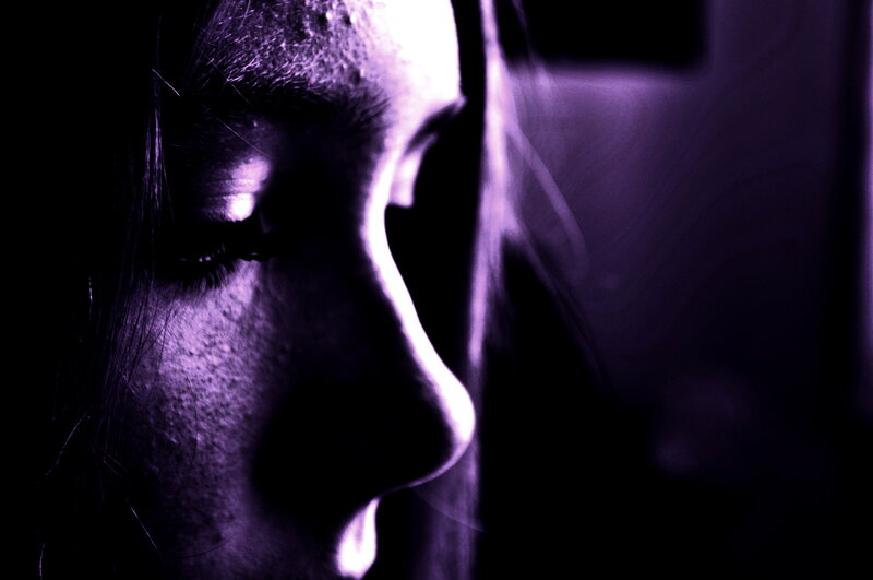 purple-lit profile portrait