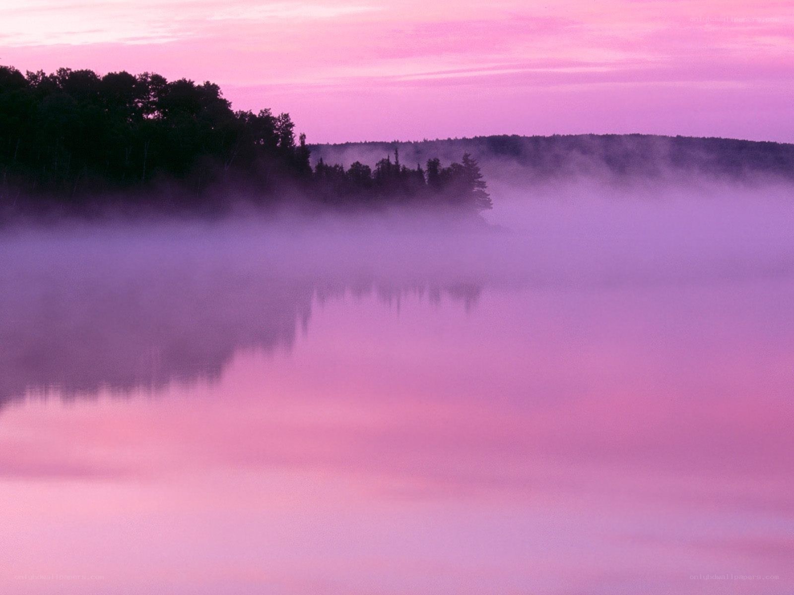 Purple mist over a calm lake