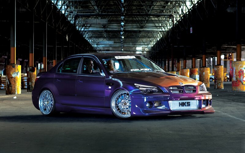 purple modified sedan in warehouse