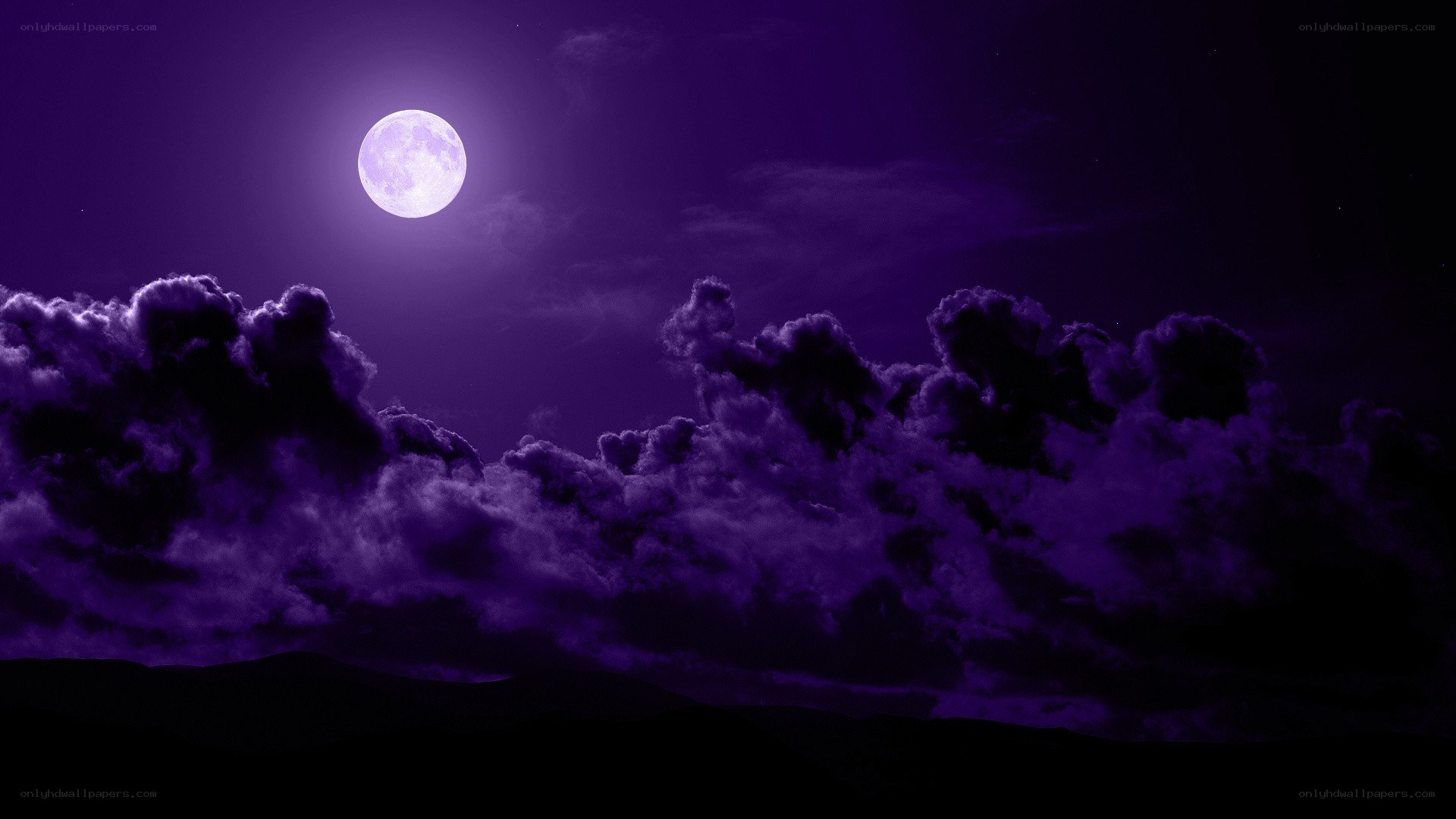 Purple moon over clouds