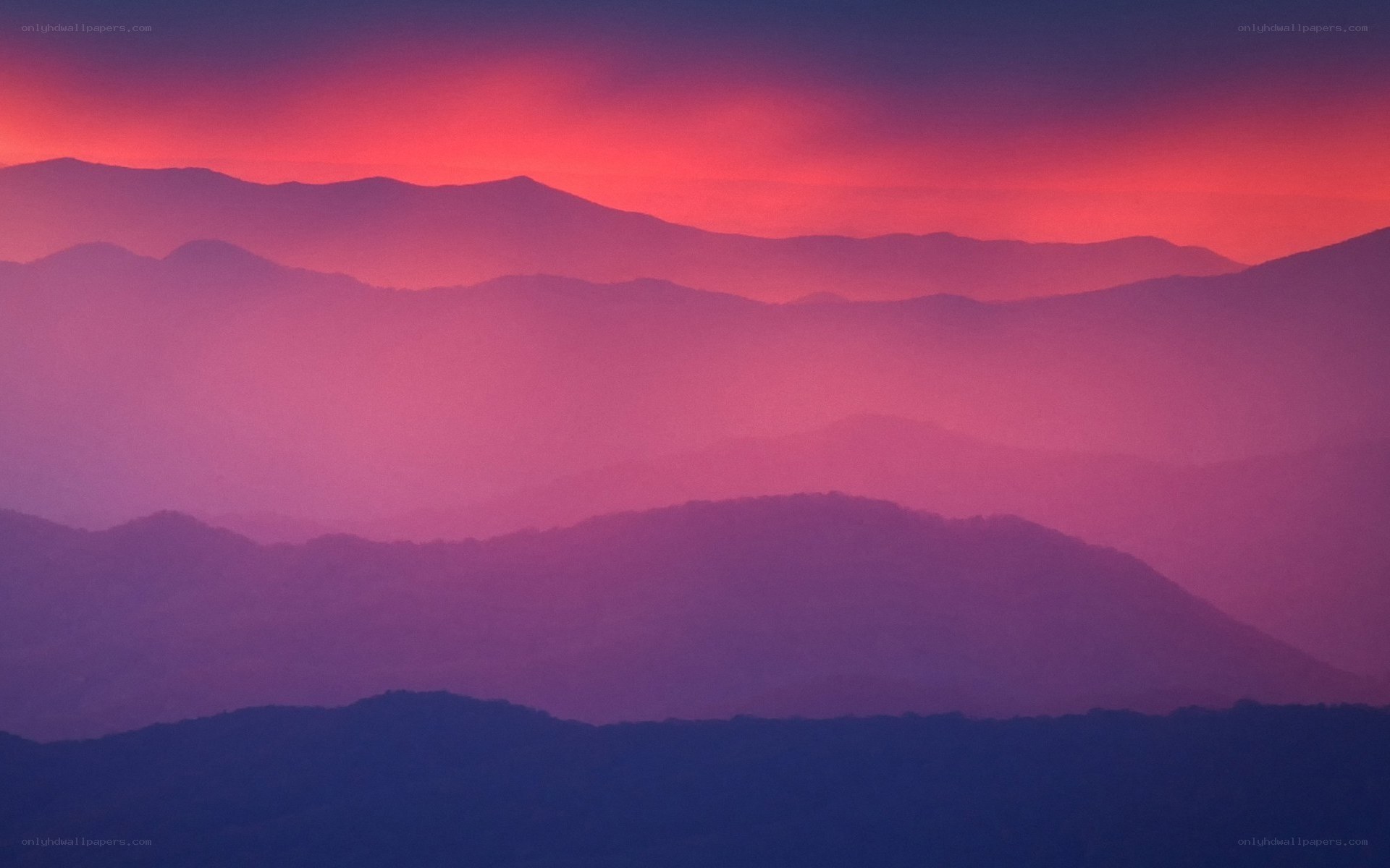 Purple mountain silhouettes at sunset