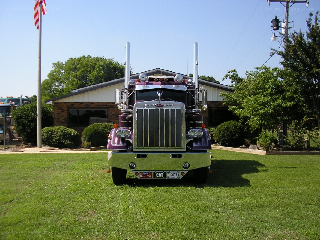 purple Peterbilt truck on lawn