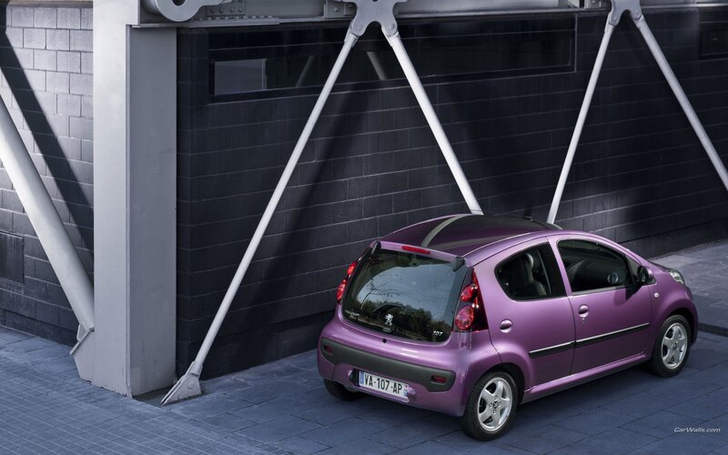 Purple Peugeot 107 parked under bridge