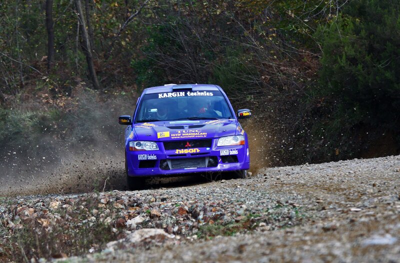 Purple rally car on dirt road