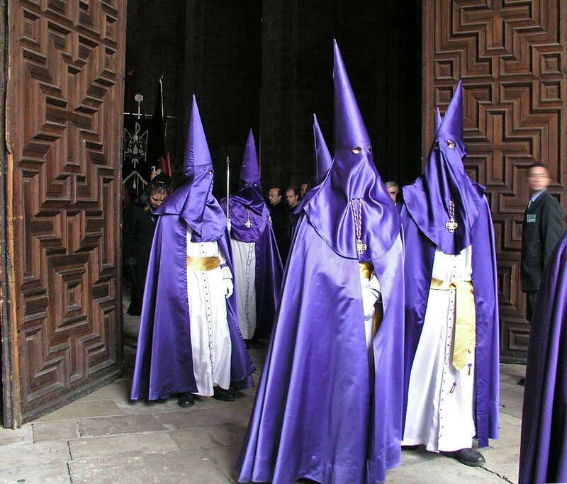 Purple-robed figures in procession