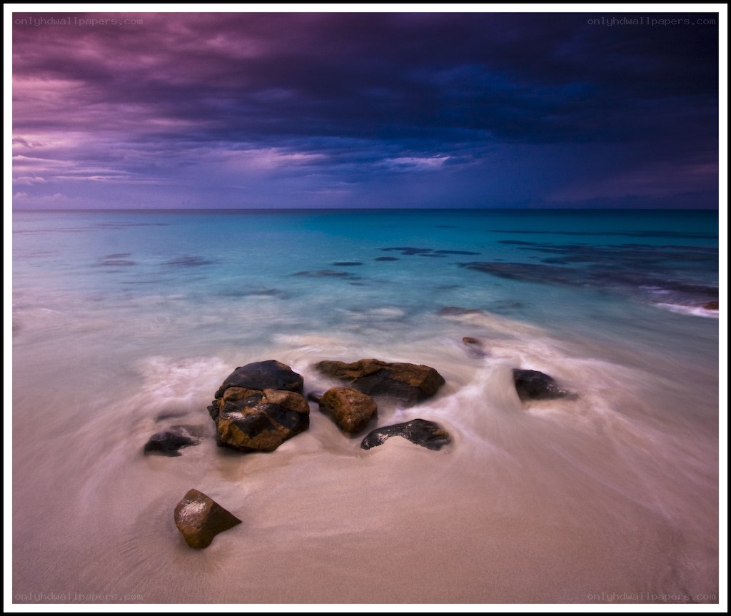 Purple sky over calm beach