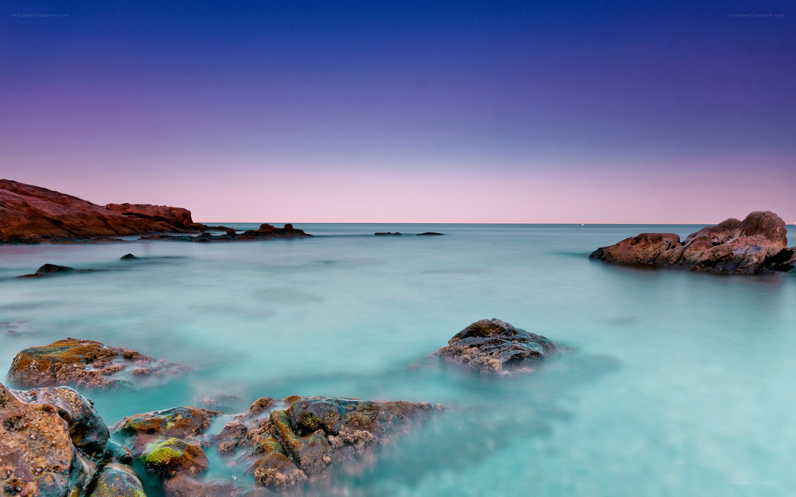 Purple sky over calm sea