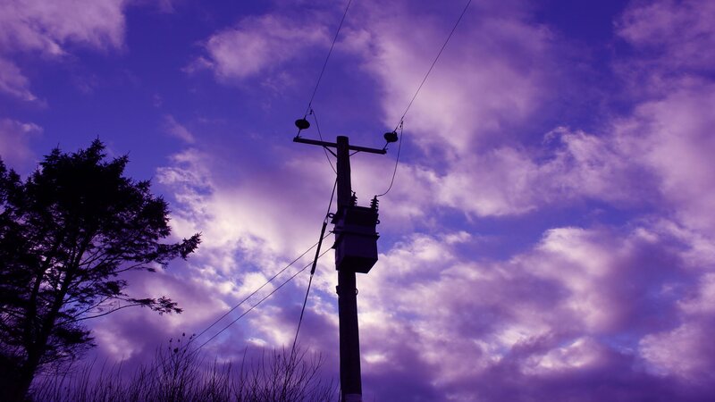 Purple sky with utility pole