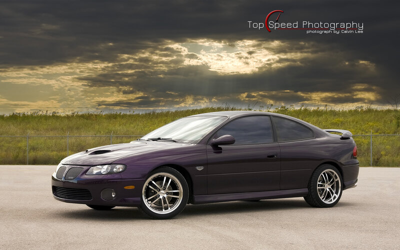 purple sports car at sunset