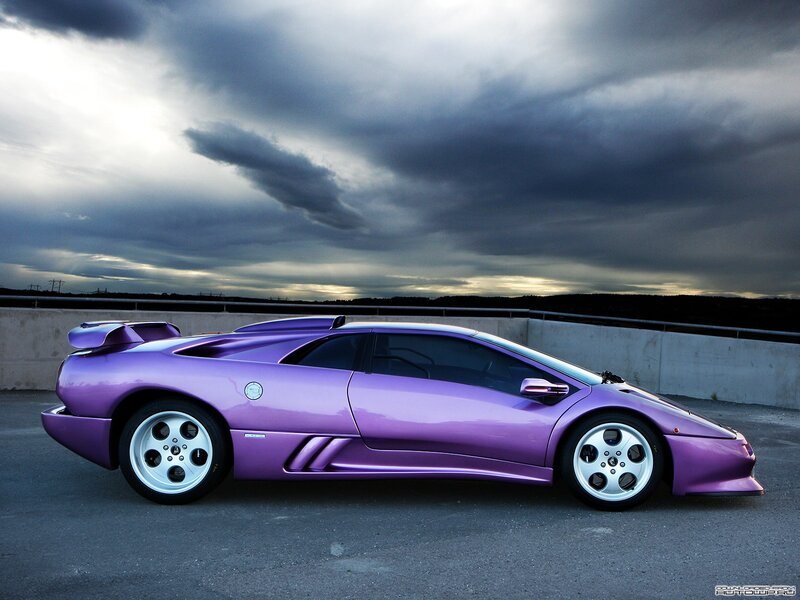 purple sports car under stormy sky