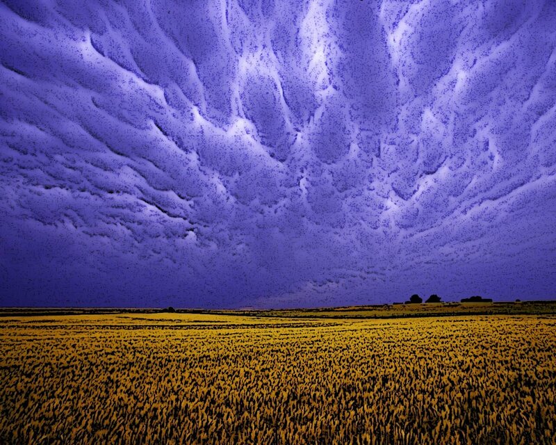 Purple storm clouds over field