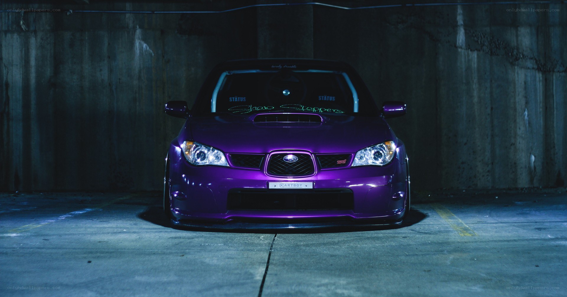 purple subaru in garage