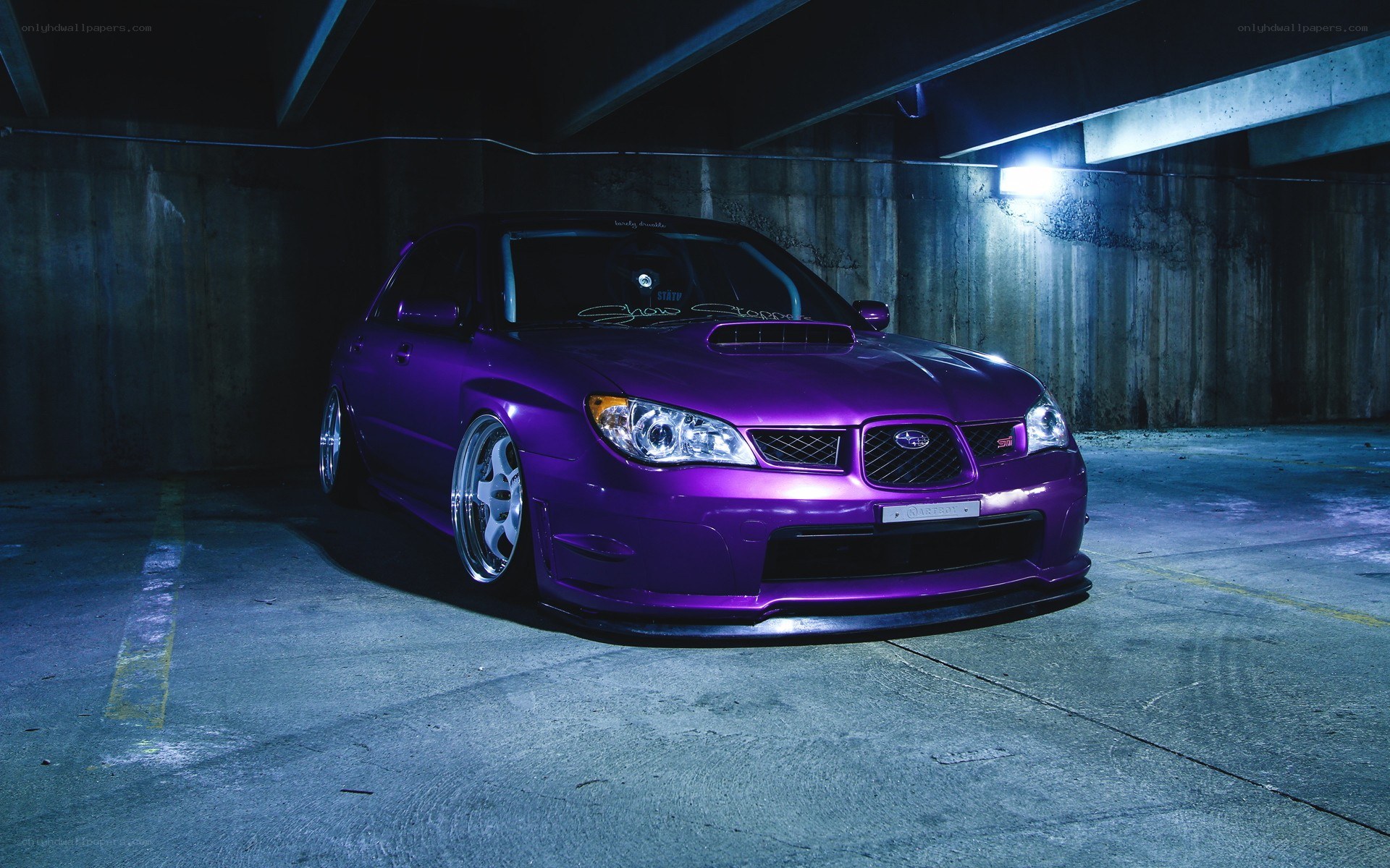 purple subaru in parking garage
