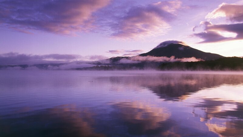 Purple sunrise over mountain lake
