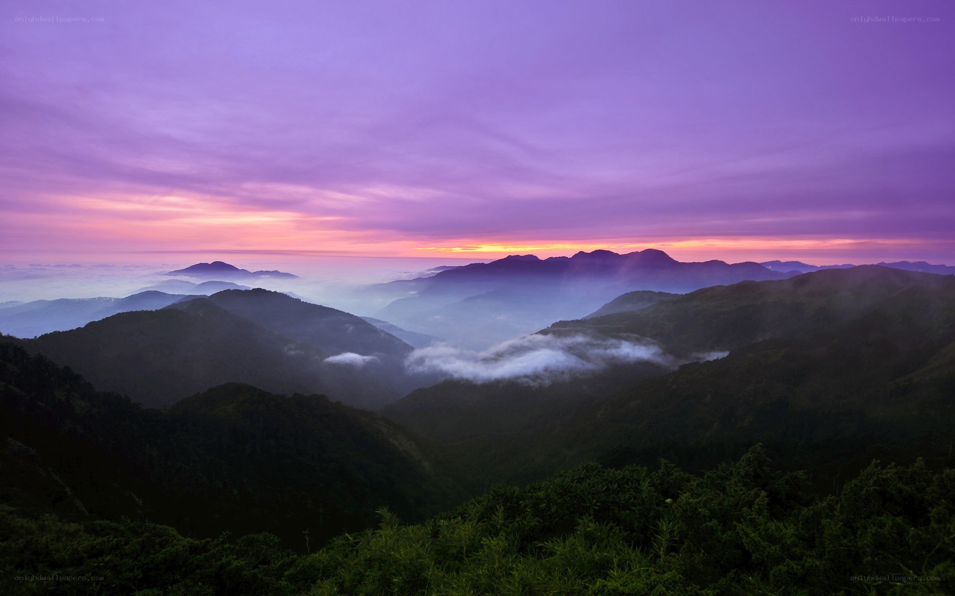Purple sunrise over mountain peaks