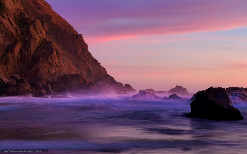 Purple sunset at rocky coast