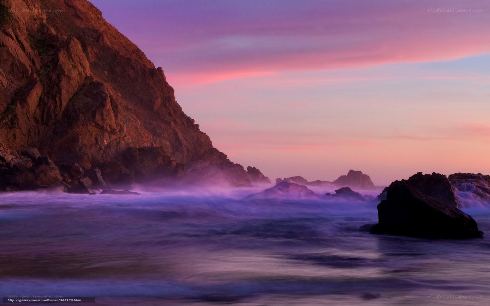 Purple sunset at rocky coast