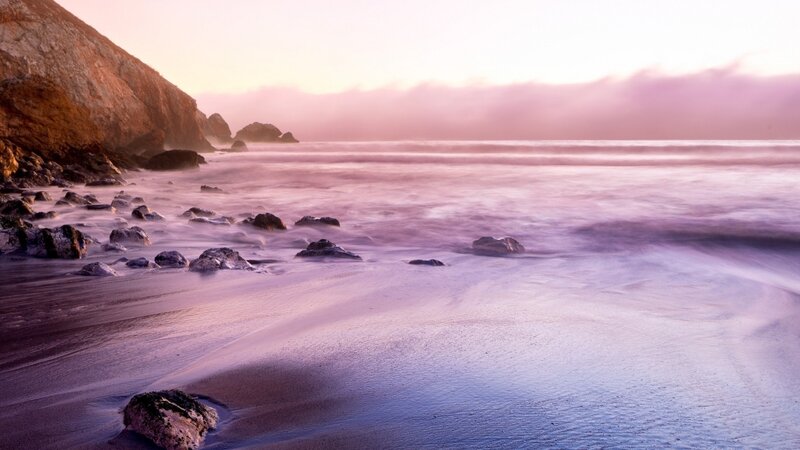 Purple sunset at the rocky beach