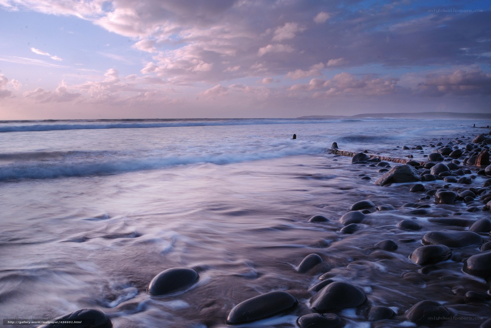 Purple sunset on a rocky beach