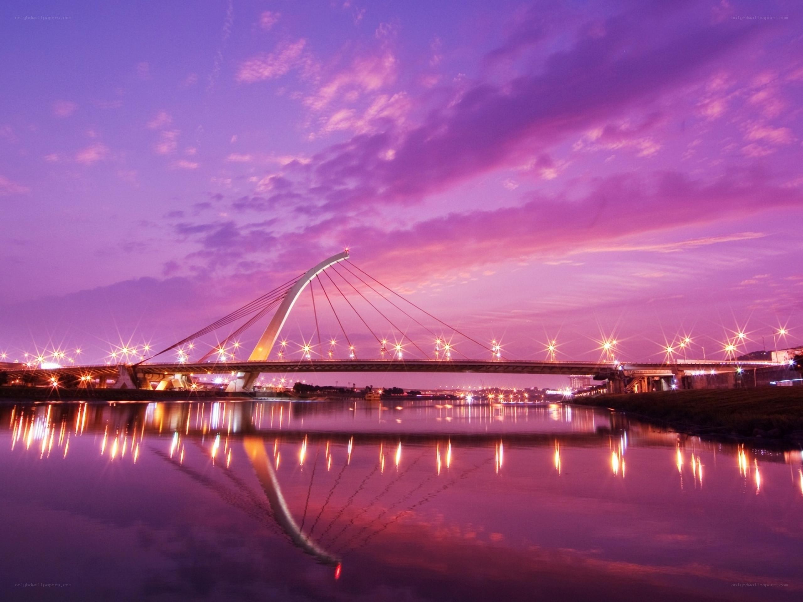 Purple sunset over a cable-stayed bridge