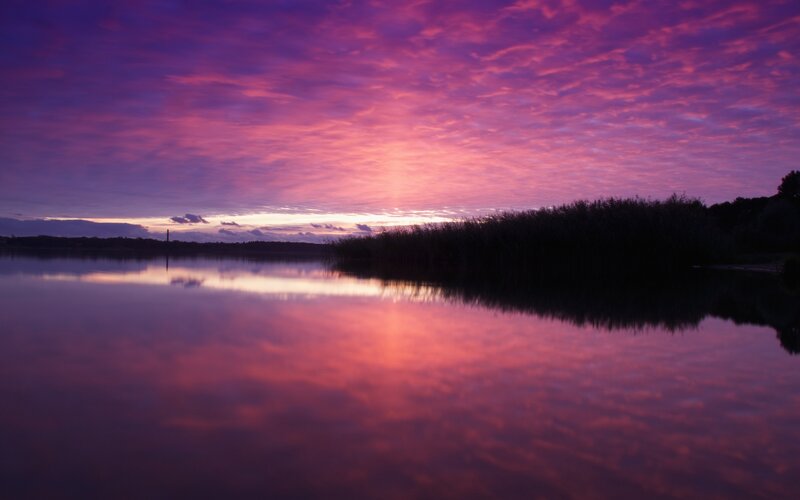 Purple sunset over a calm lake
