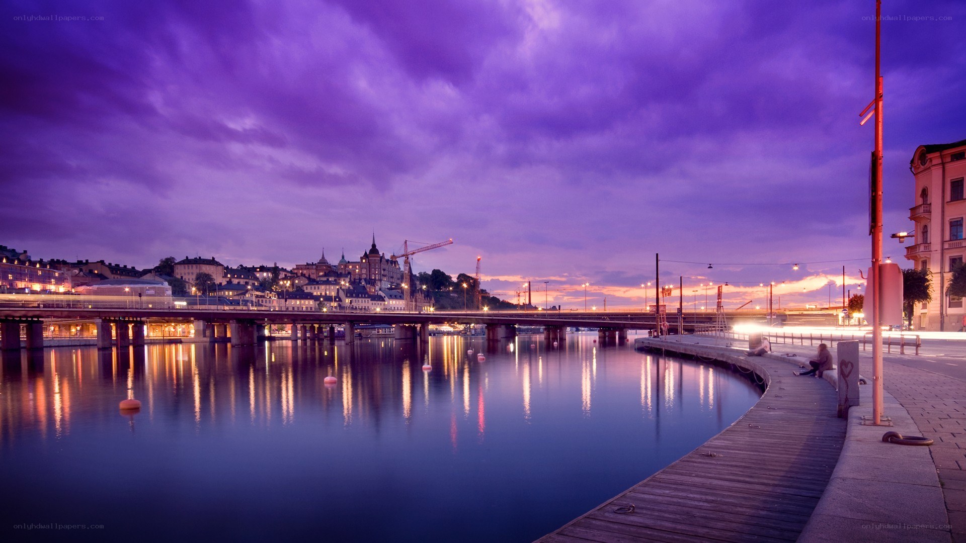 Purple sunset over a city bridge