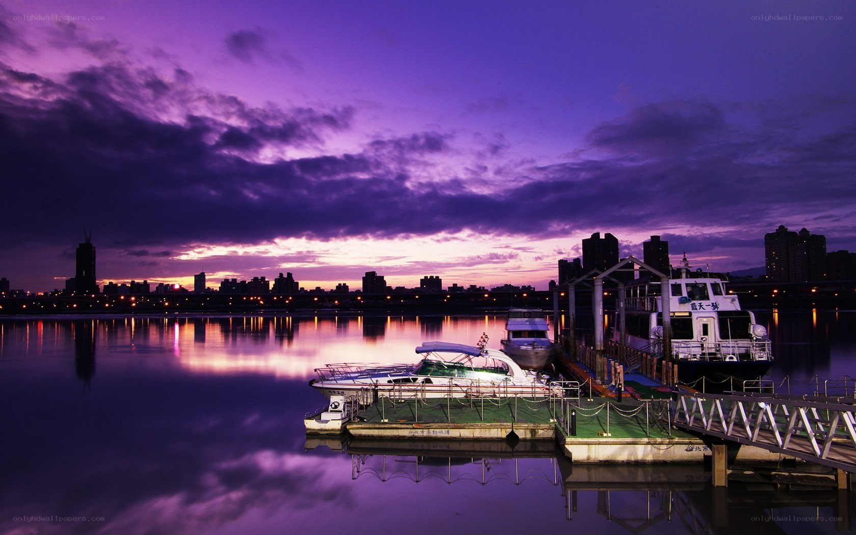 Purple sunset over a city harbor