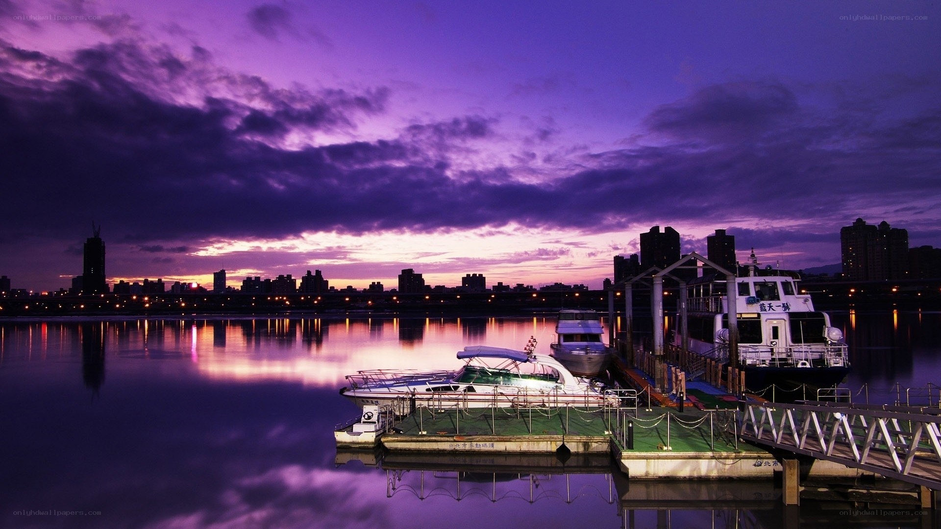 Purple sunset over a city harbor
