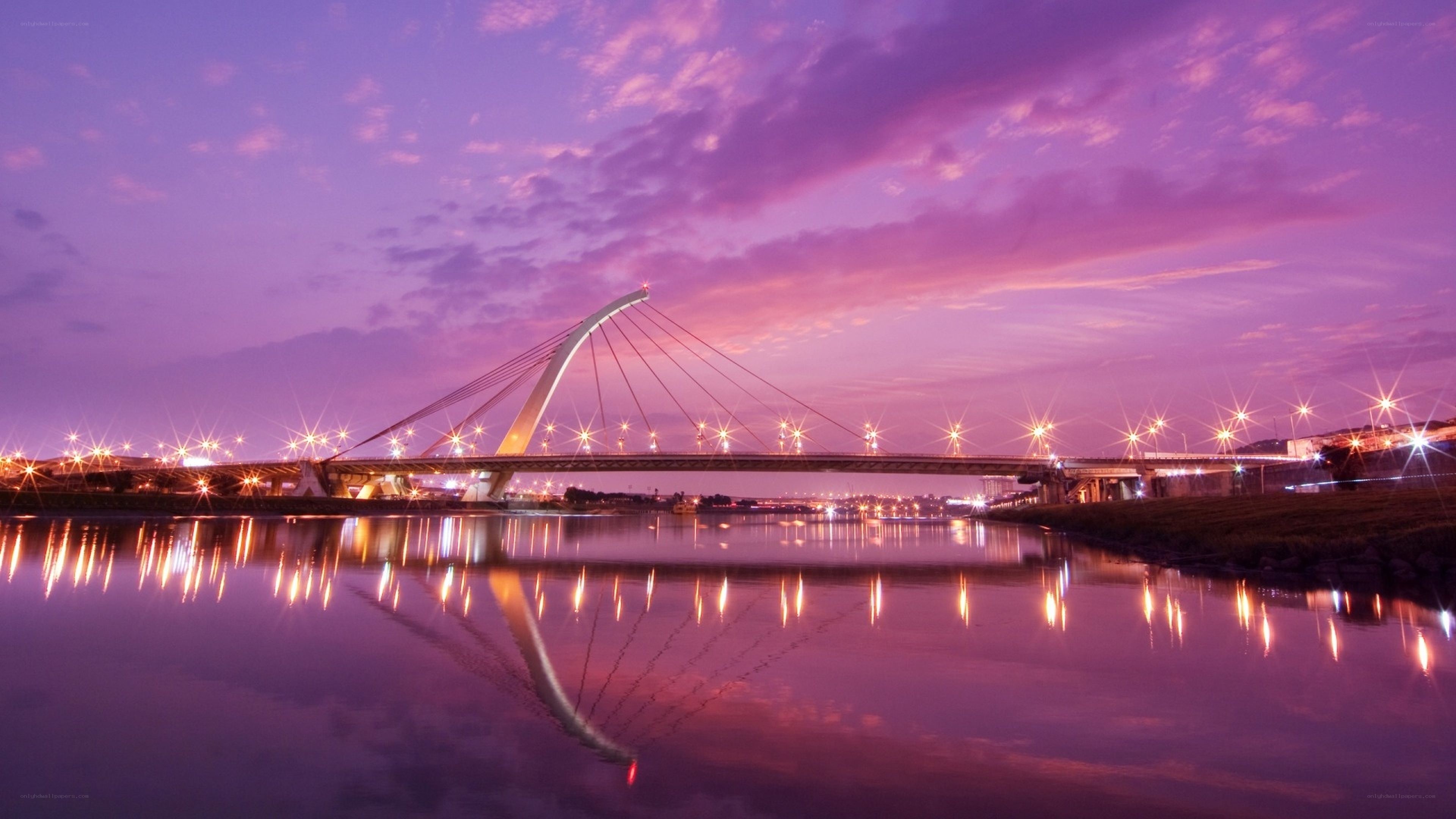 Purple sunset over a modern bridge