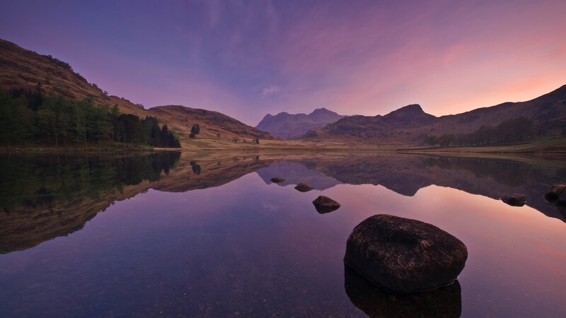 Purple sunset over a mountain lake