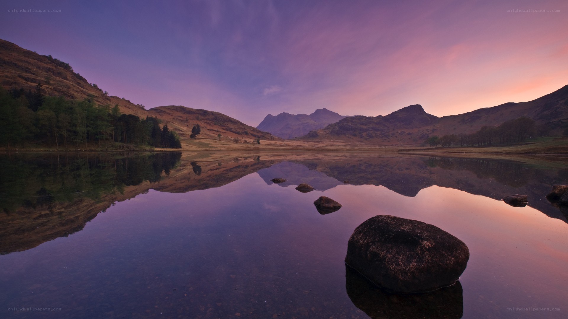 Purple sunset over a mountain lake