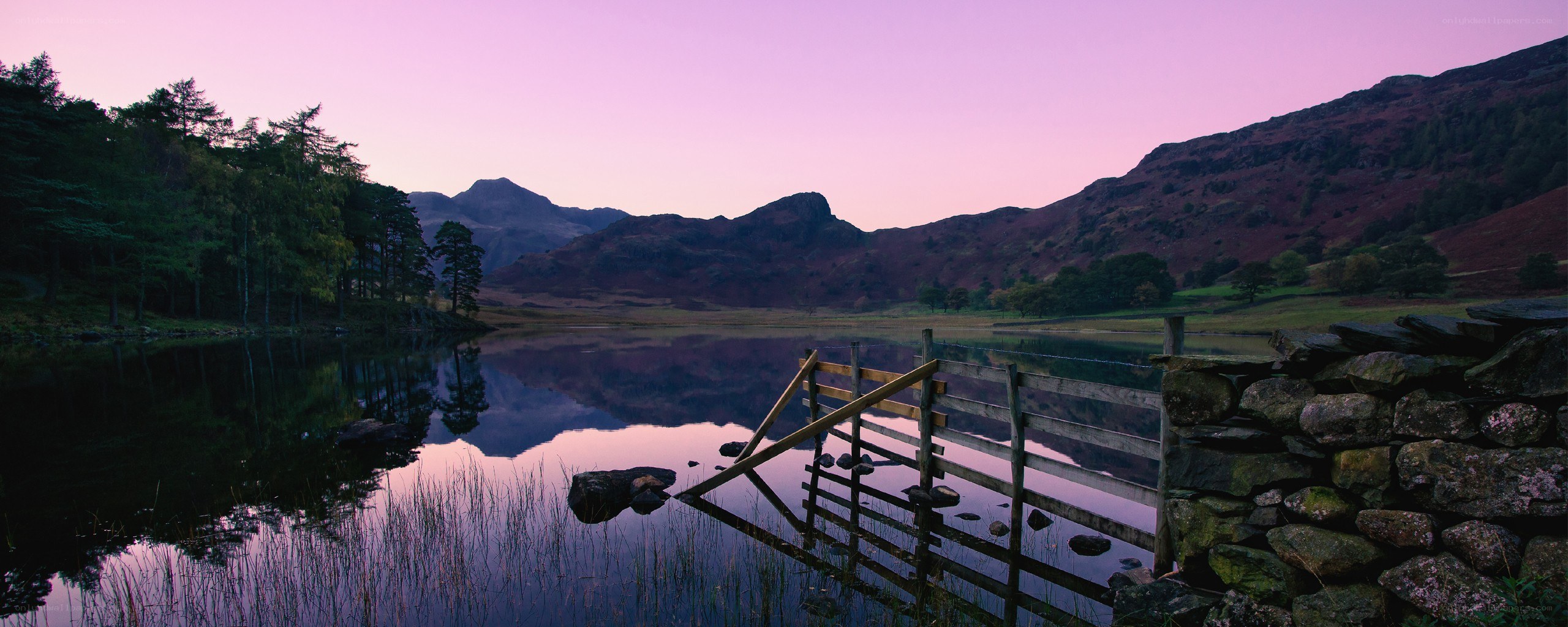 Purple sunset over a mountain lake