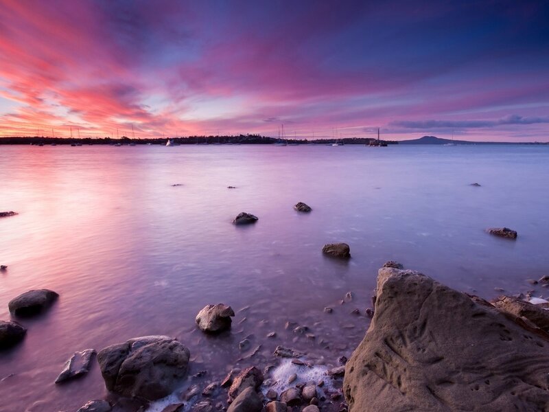 Purple sunset over calm bay