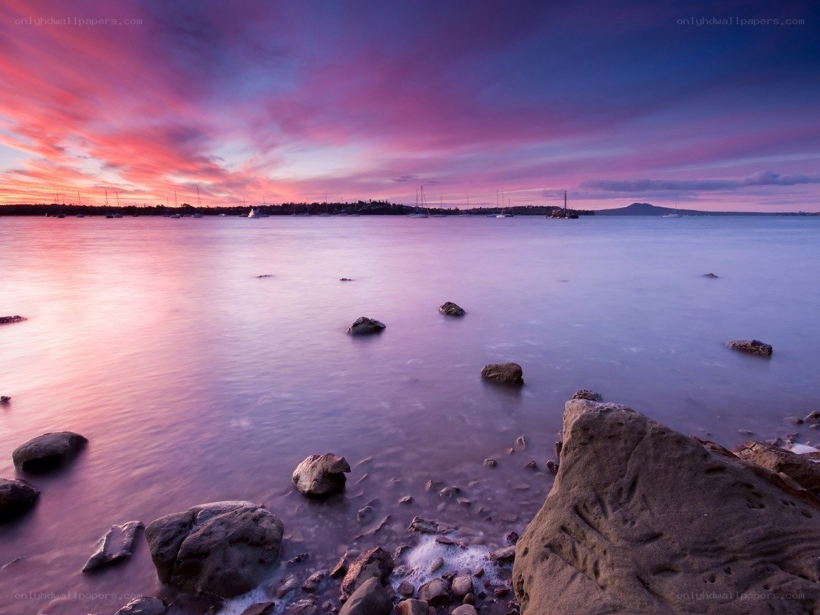 Purple sunset over calm bay