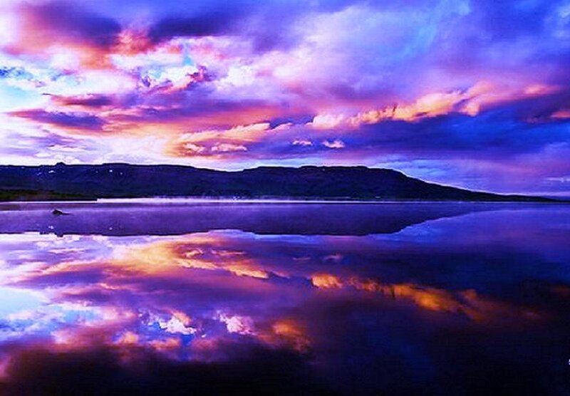 Purple sunset over calm lake
