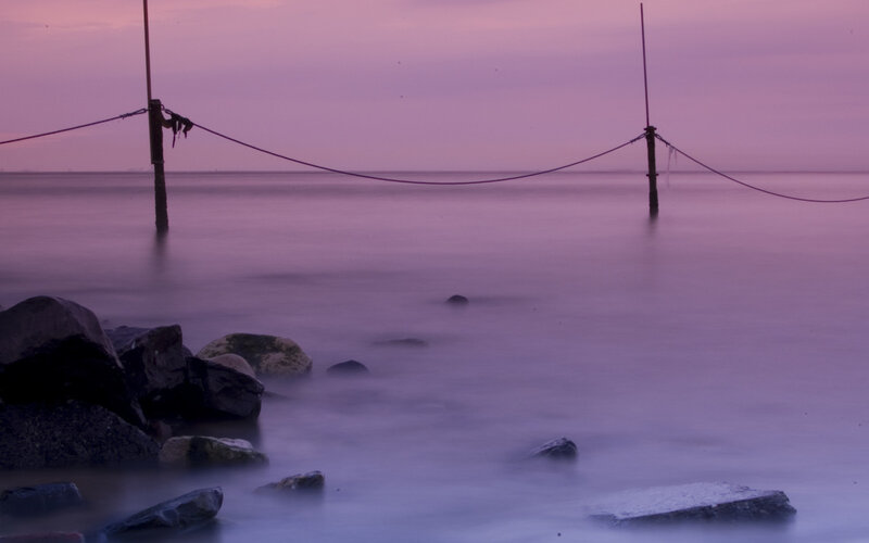Purple sunset over calm sea