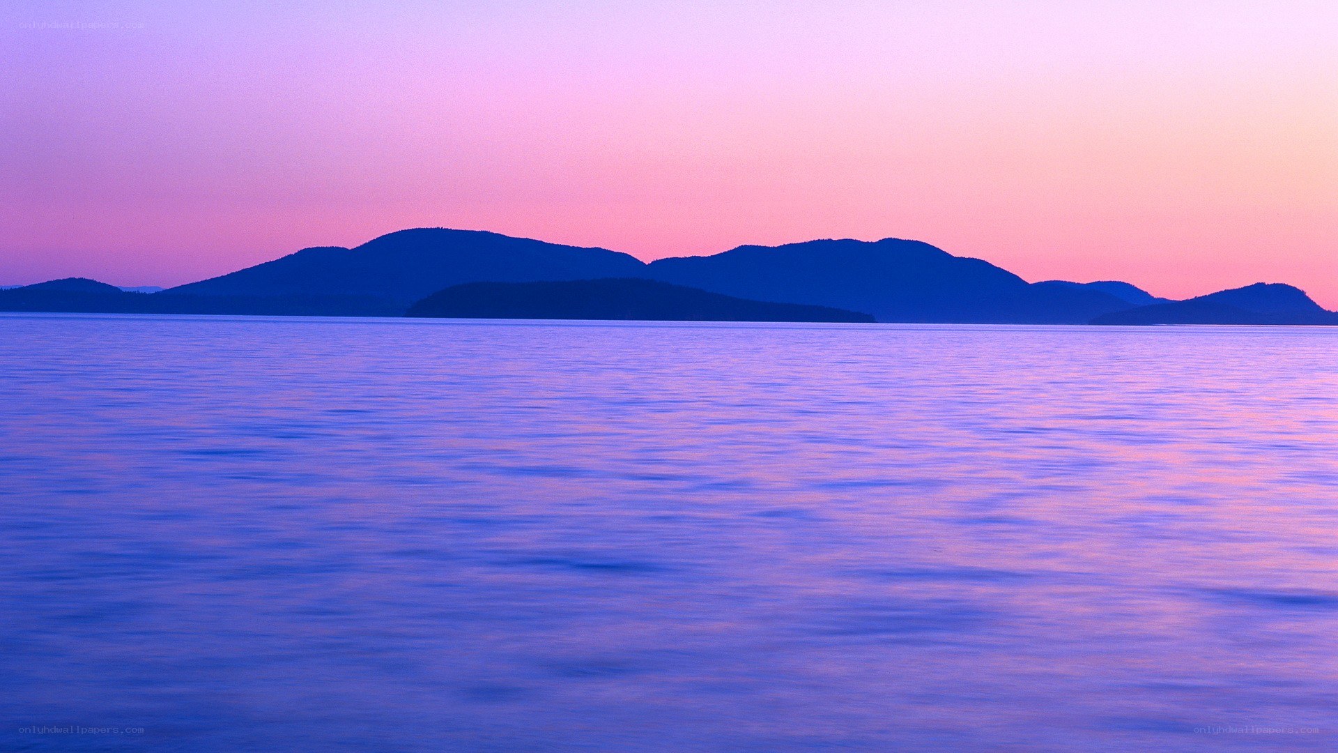 Purple sunset over calm water