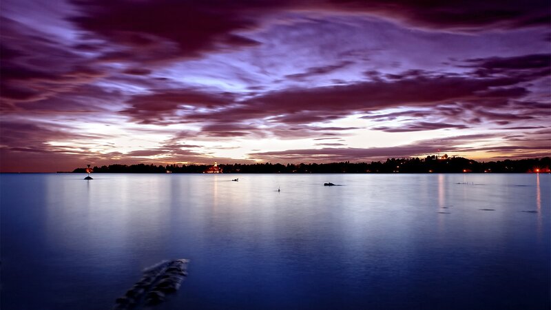 Purple sunset over calm water