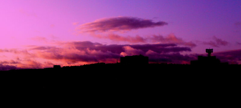 purple sunset over city silhouette
