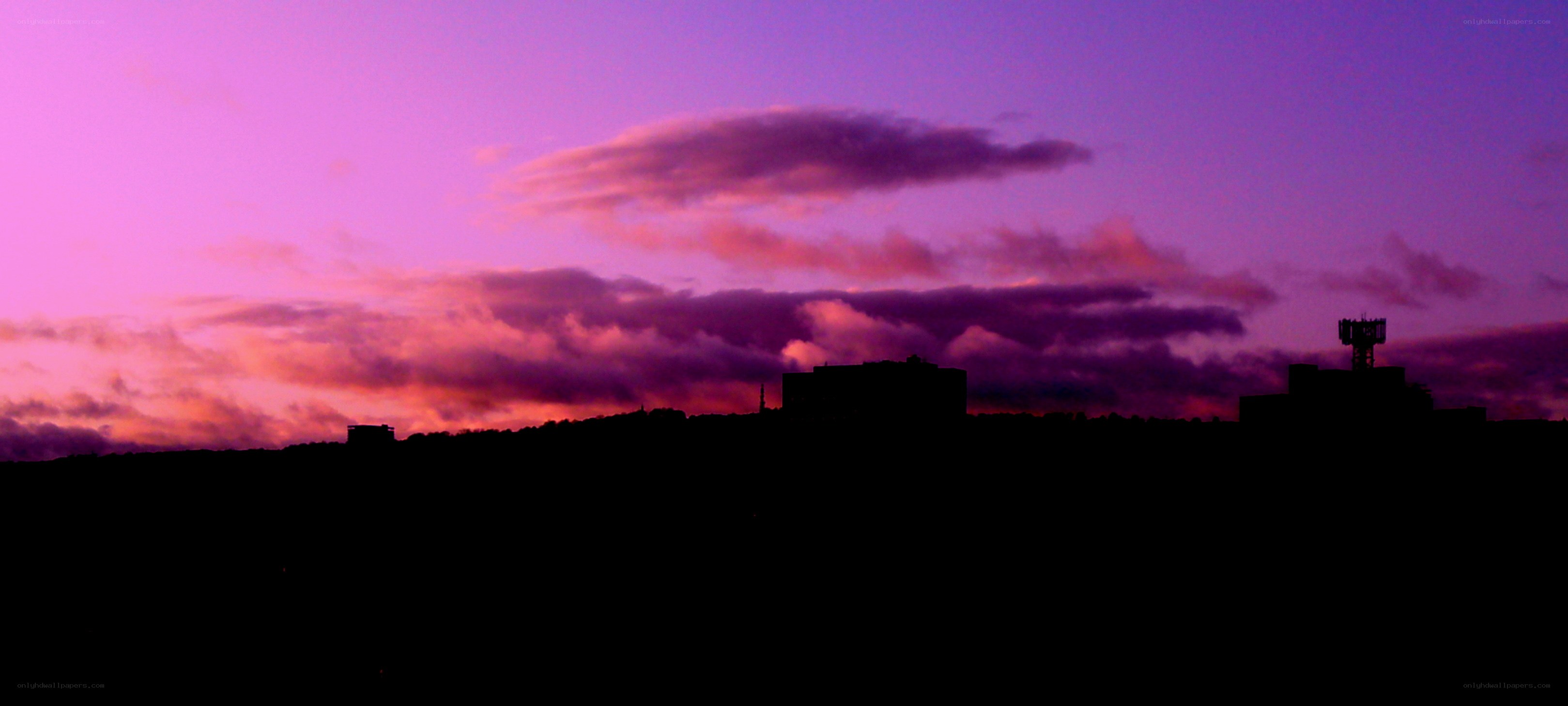 purple sunset over city silhouette