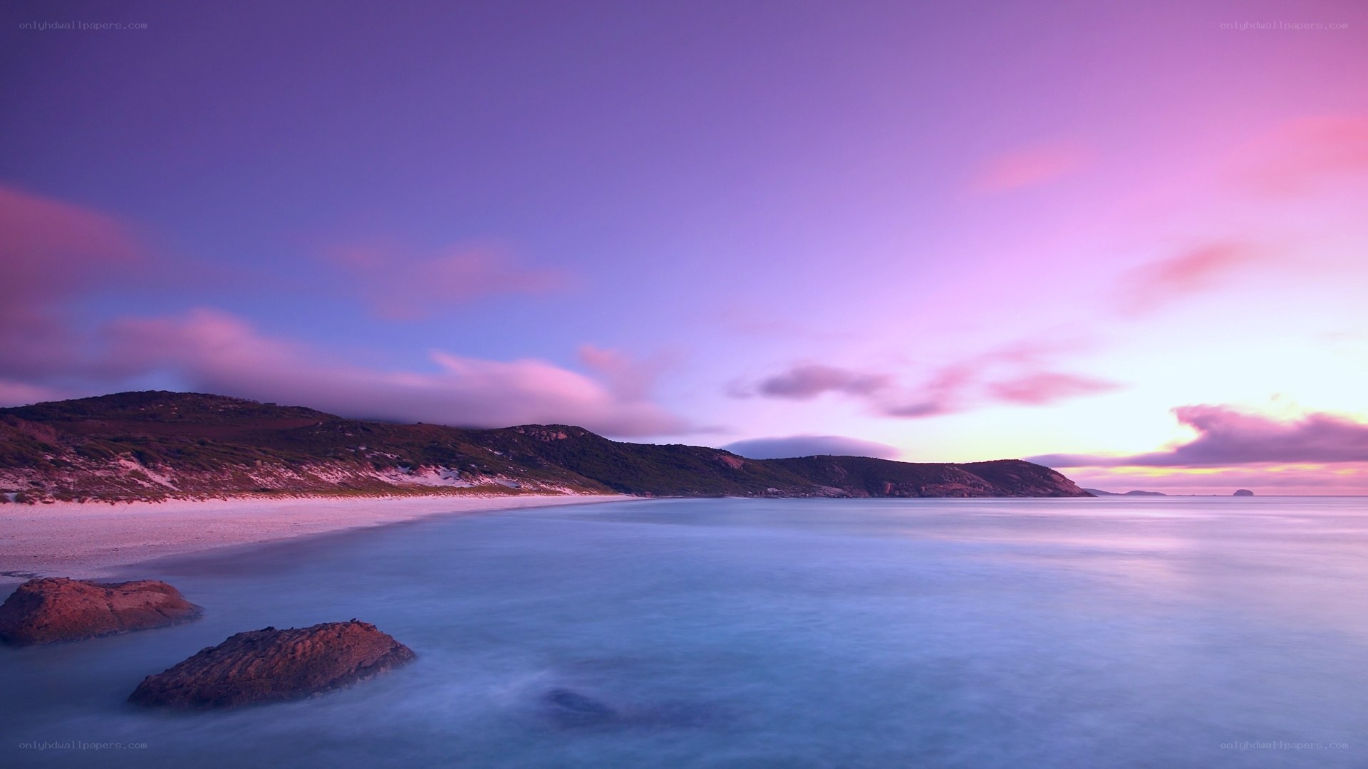Purple sunset over coastal beach