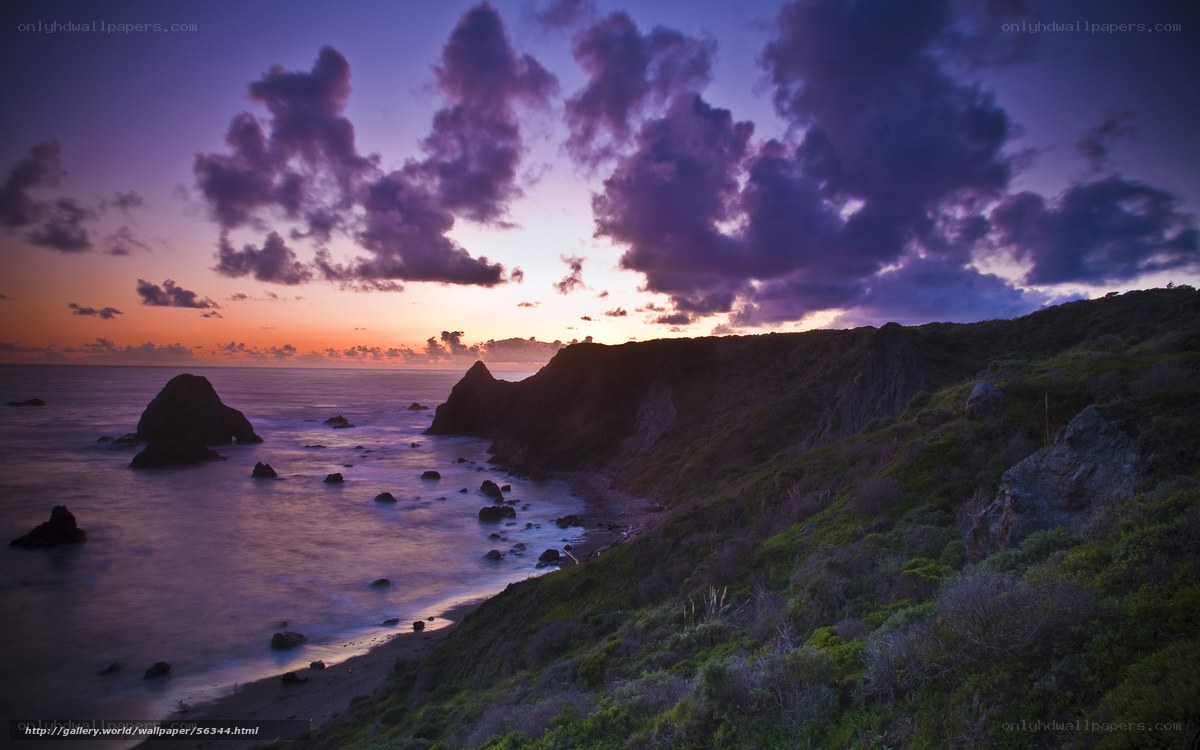 Purple sunset over coastal cliffs