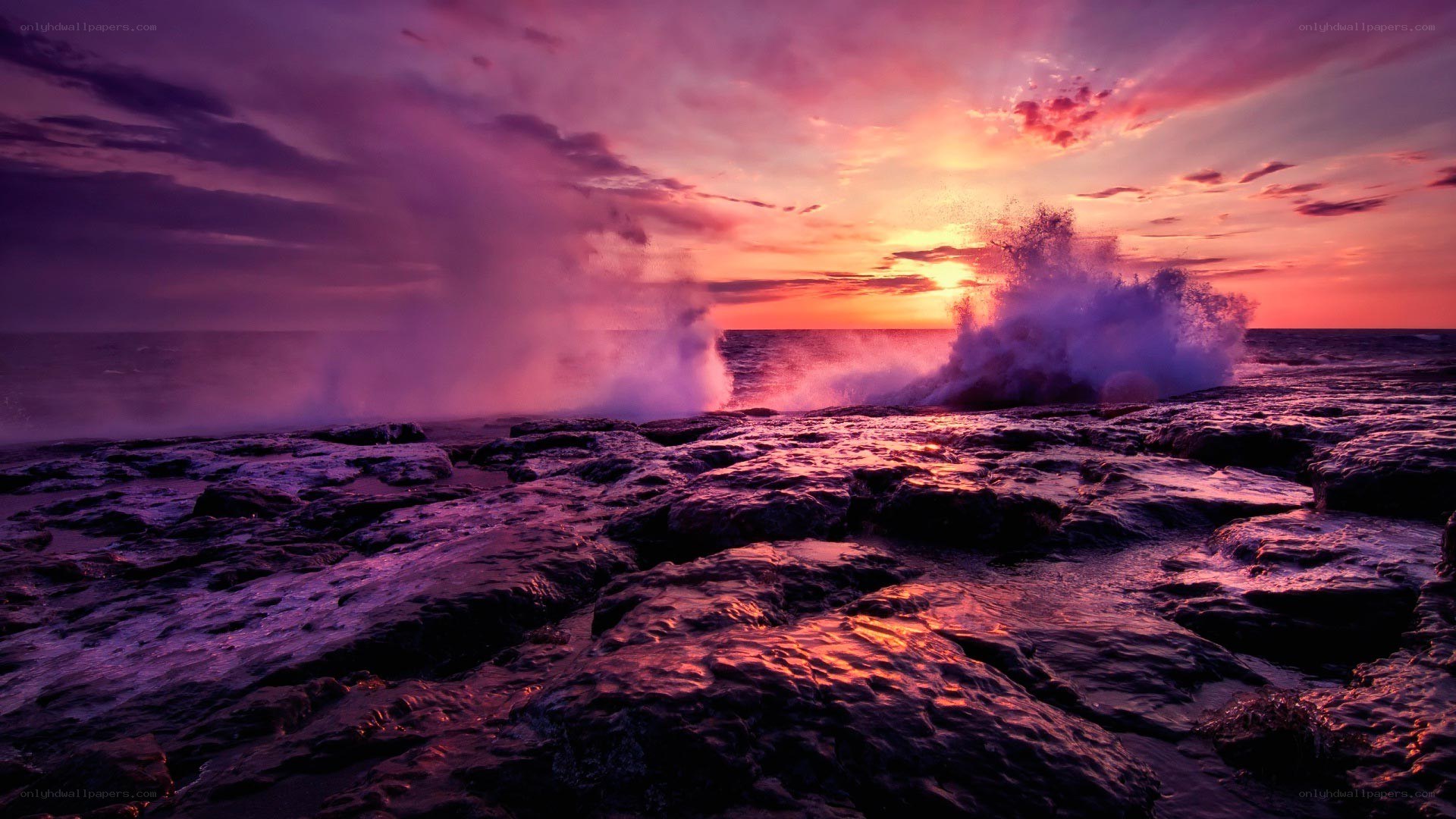 Purple sunset over crashing waves